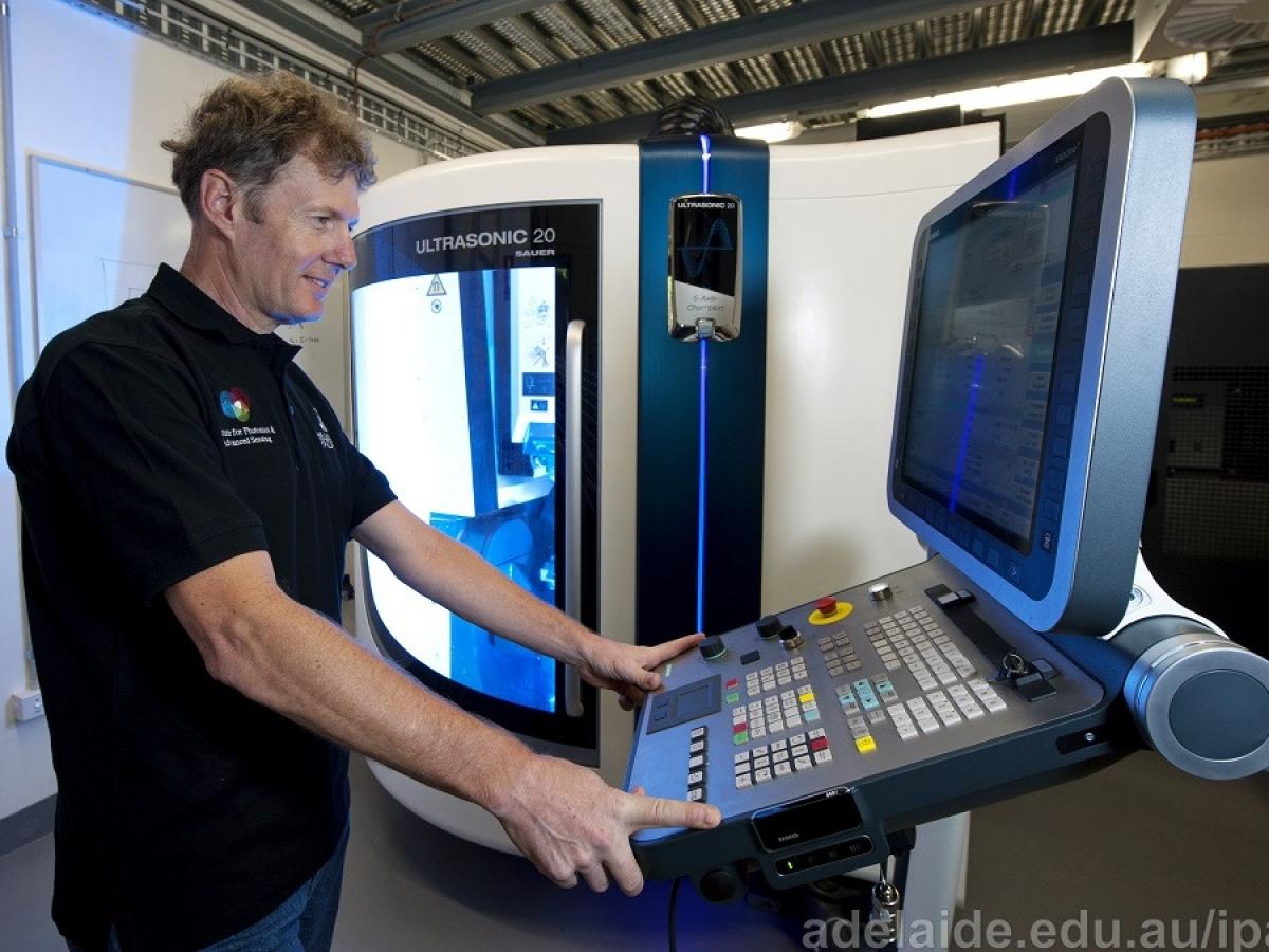5-axis CNC Ultrasonic machining technician working