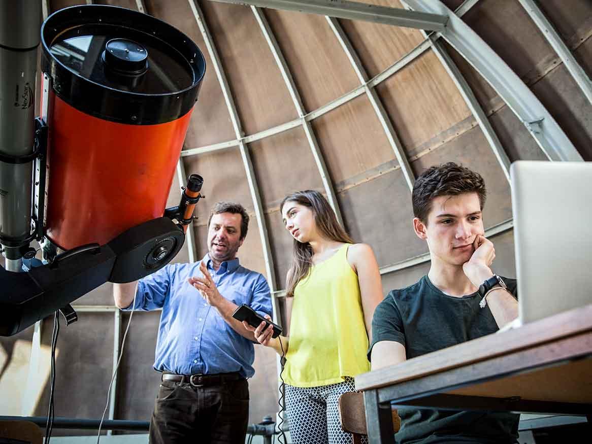 Lecturer with students in science observatory