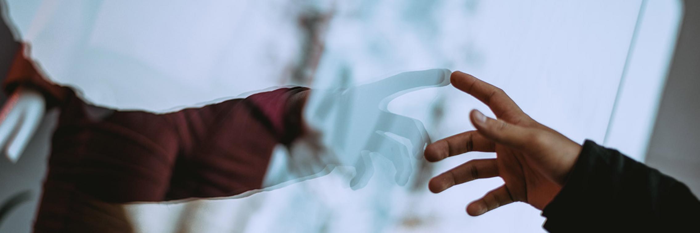 Arm pointing, reflection in a window
