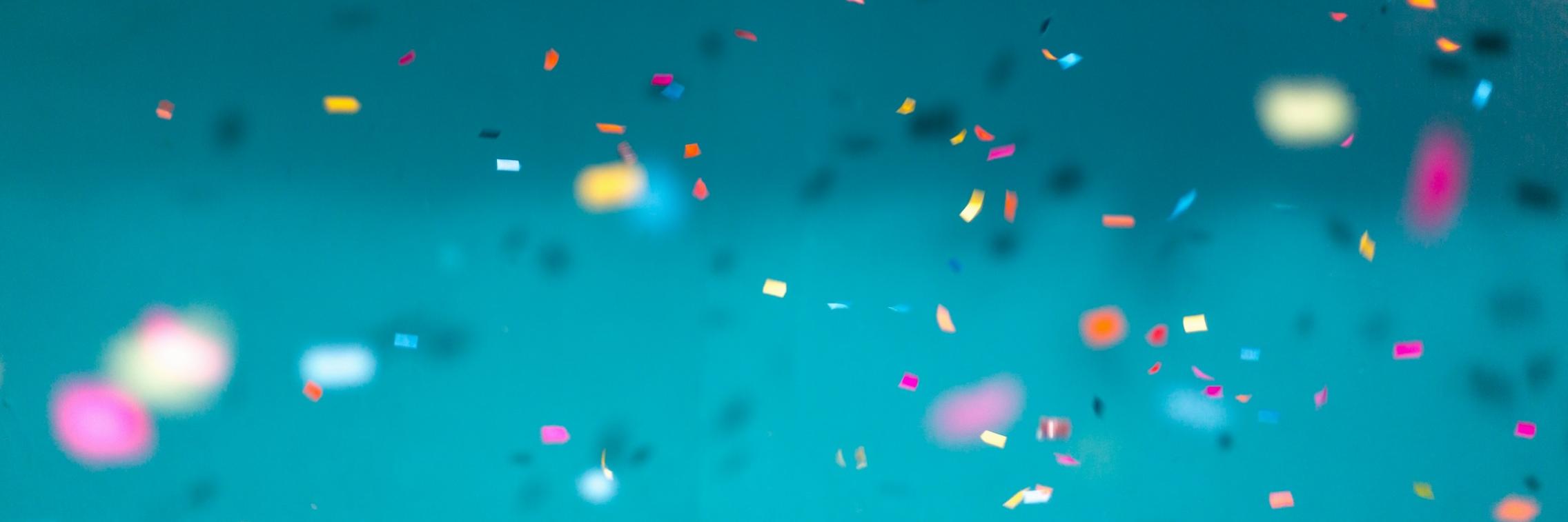 Confetti falling against blue background