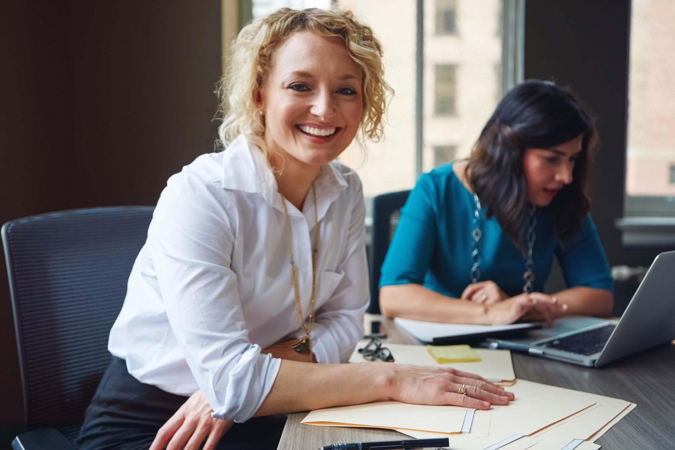 smiling female sitting at desk