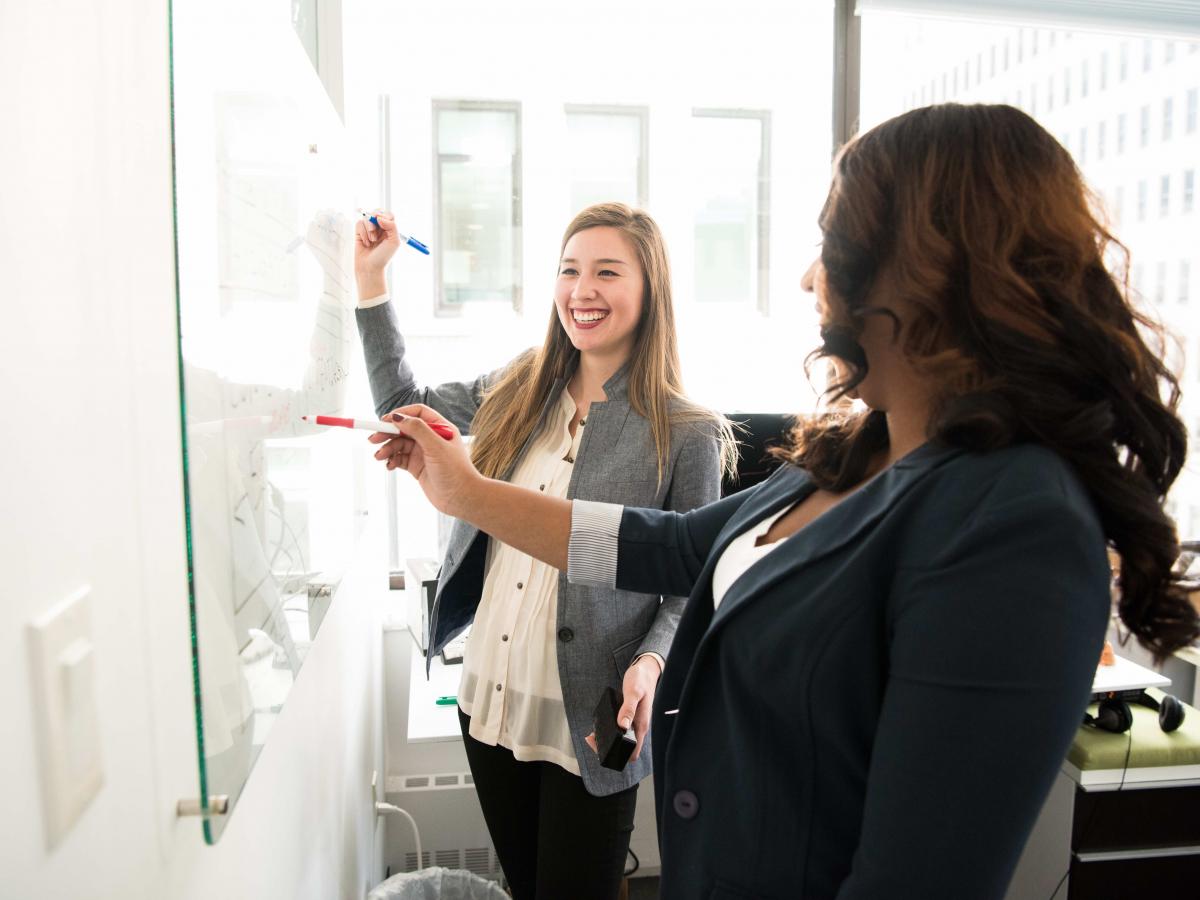 People collaborating on a white board