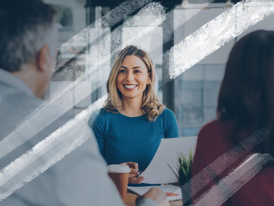 Female smiling at a desk, meeting with a couple