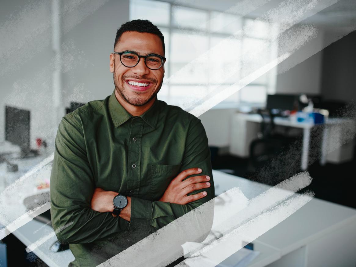Young male professional smiling in office.