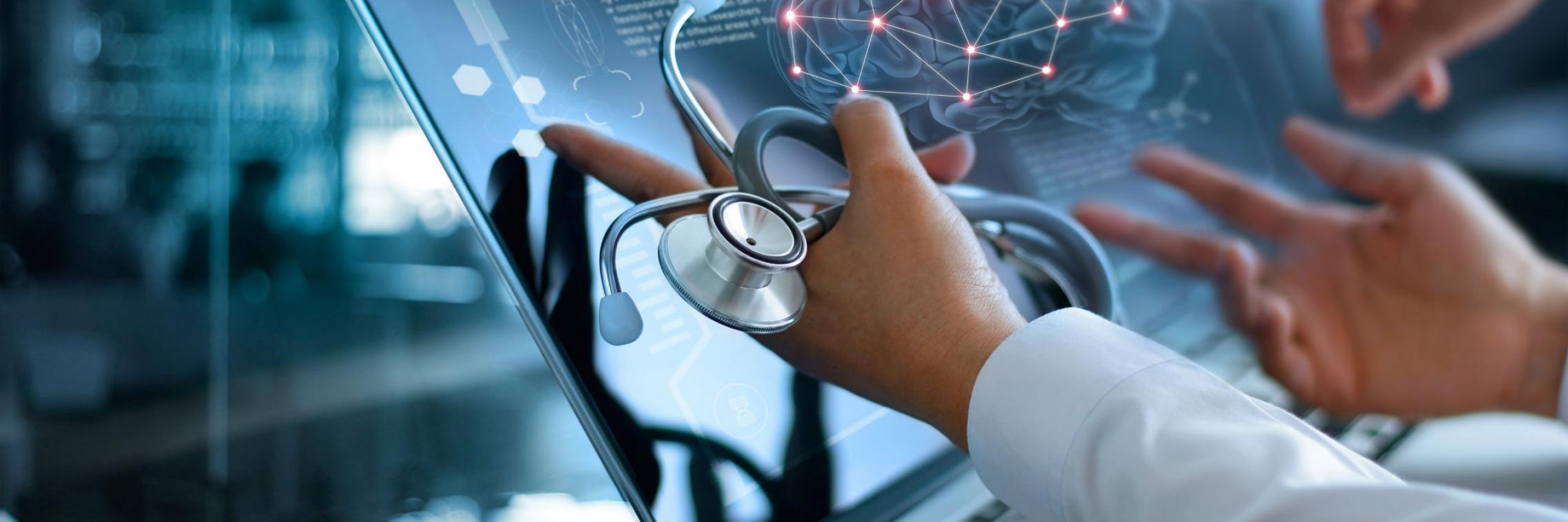 Doctors pointing at screen with brain scan