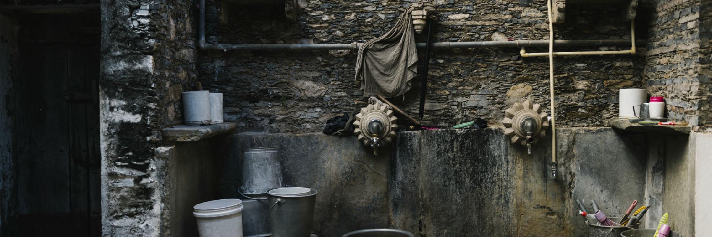 South asian laundry with buckets, harvesting rain water