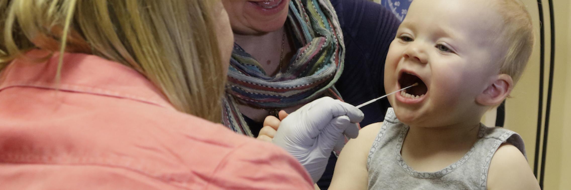 Child having a swab for research 