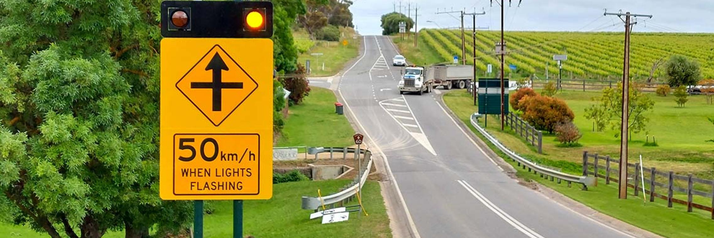 A road with a road sign on the left