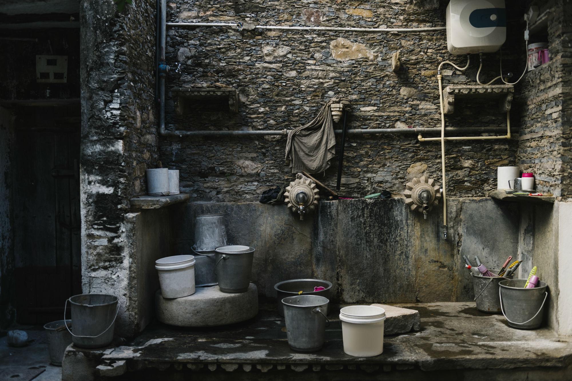 South asian laundry with buckets, harvesting rain water