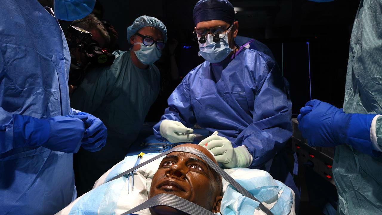 Dr Adam Wells undertaking history-making 'surgery', using the new technology.