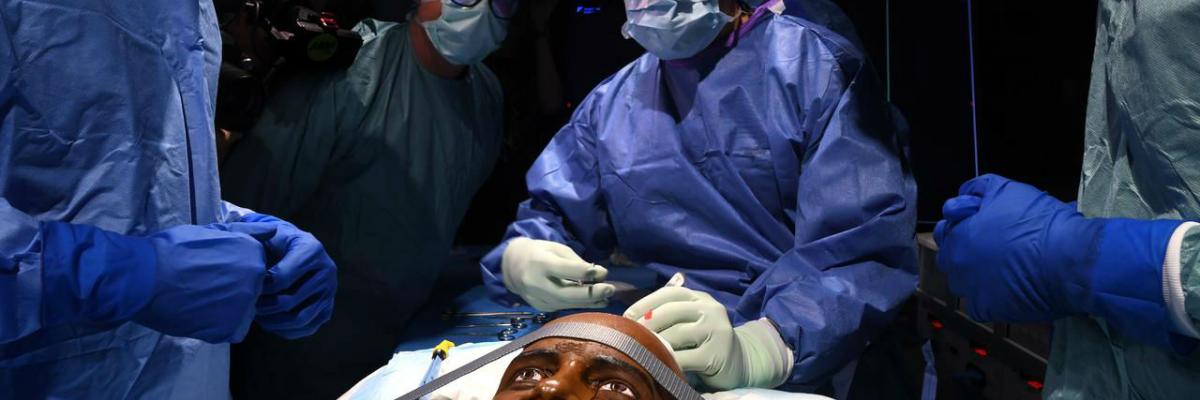 Dr Adam Wells undertaking history-making 'surgery', using the new technology.