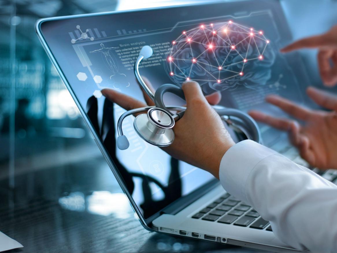 Doctors pointing at screen with brain scan
