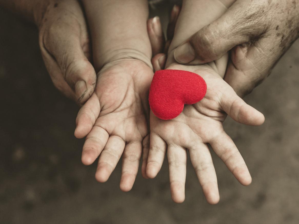 Child holding a heart 