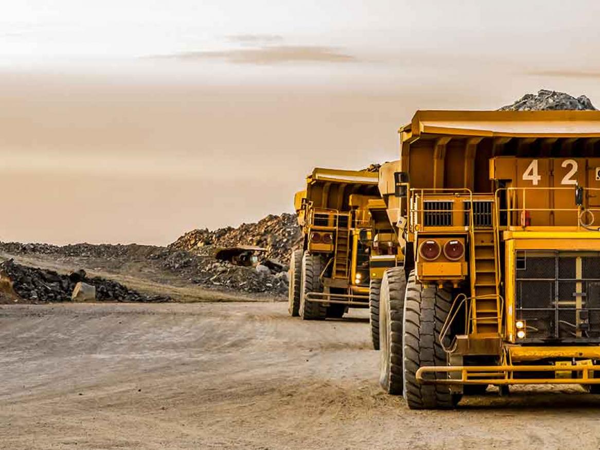 Large mining trucks transporting platinum ore for processing