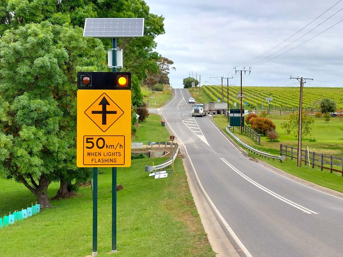 A road with a road sign on the left