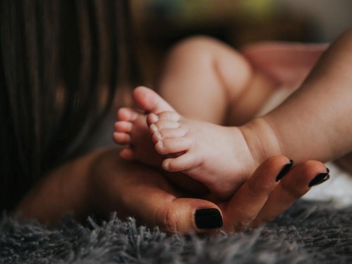 Hands holding baby's feet