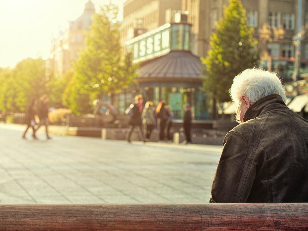 Back shot of elderly gentleman in square