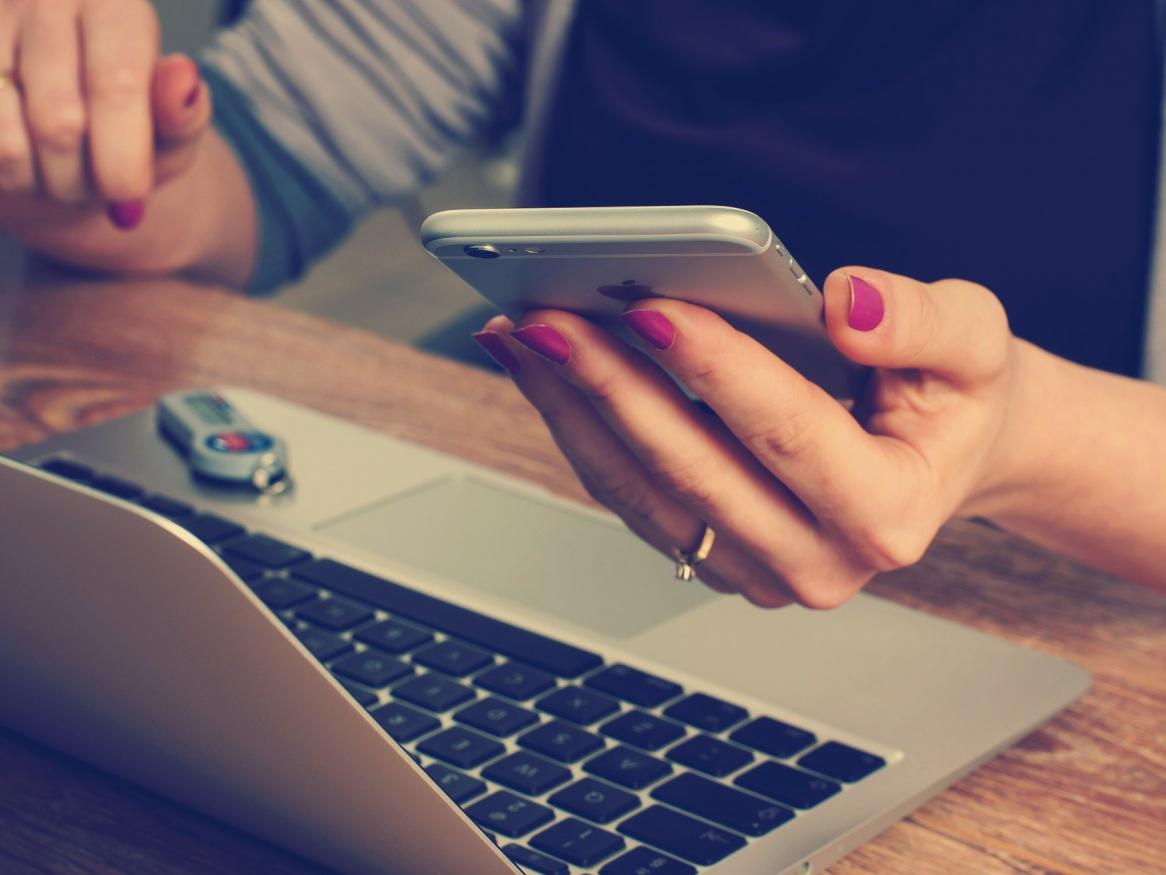 Picture of woman with phone and computer