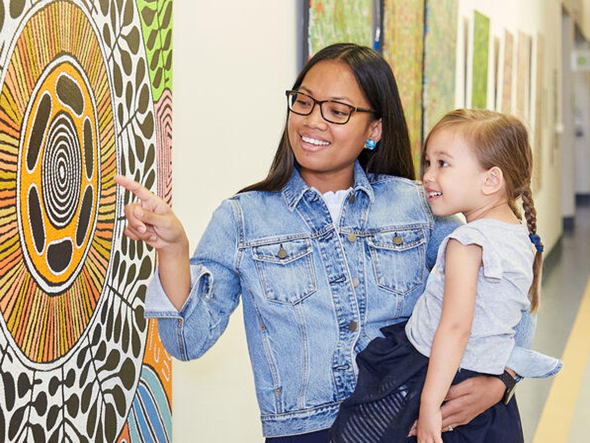 Women and child looking at art work
