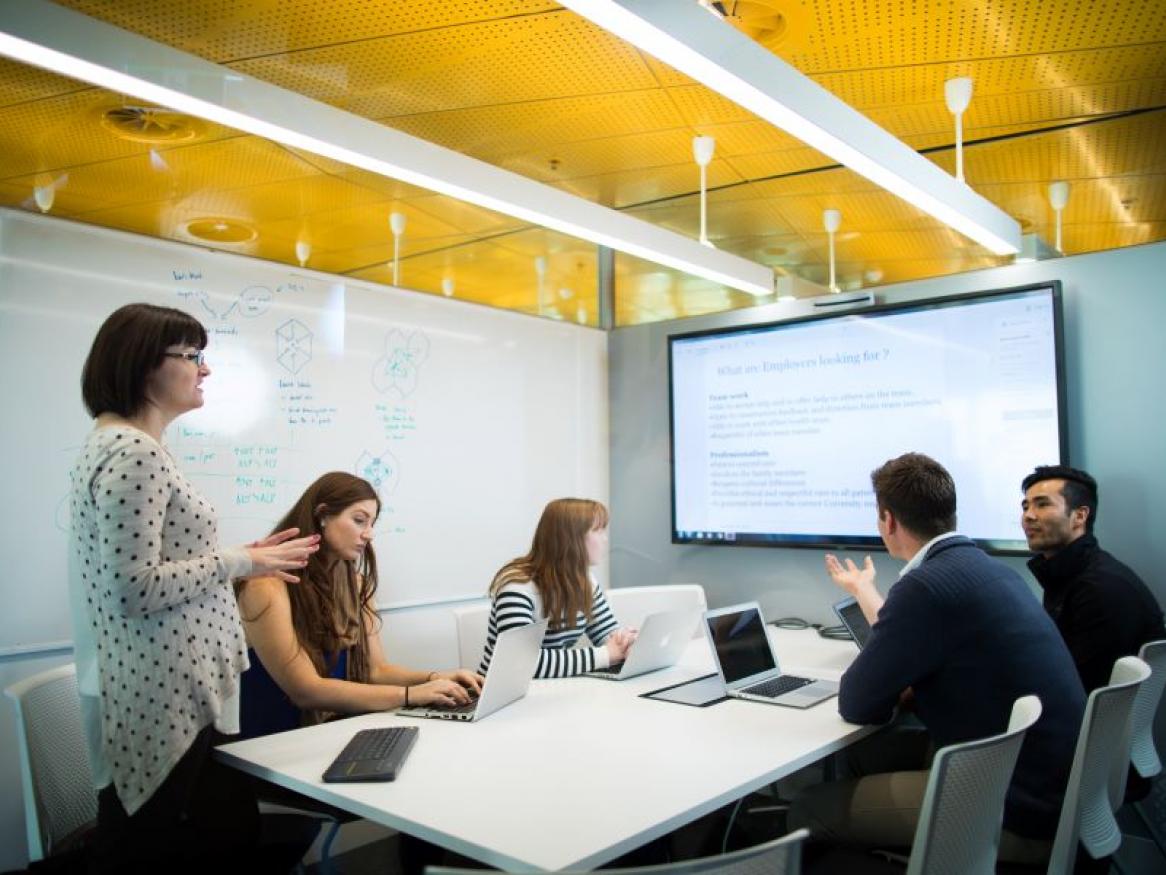 Group of people sitting around a conference table