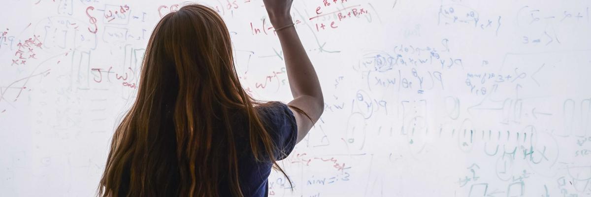 teacher writing on a white board