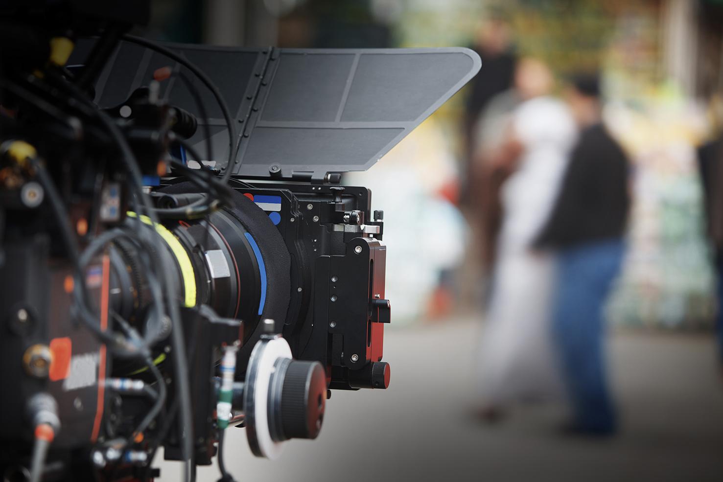 A camera focused on some people in a distance