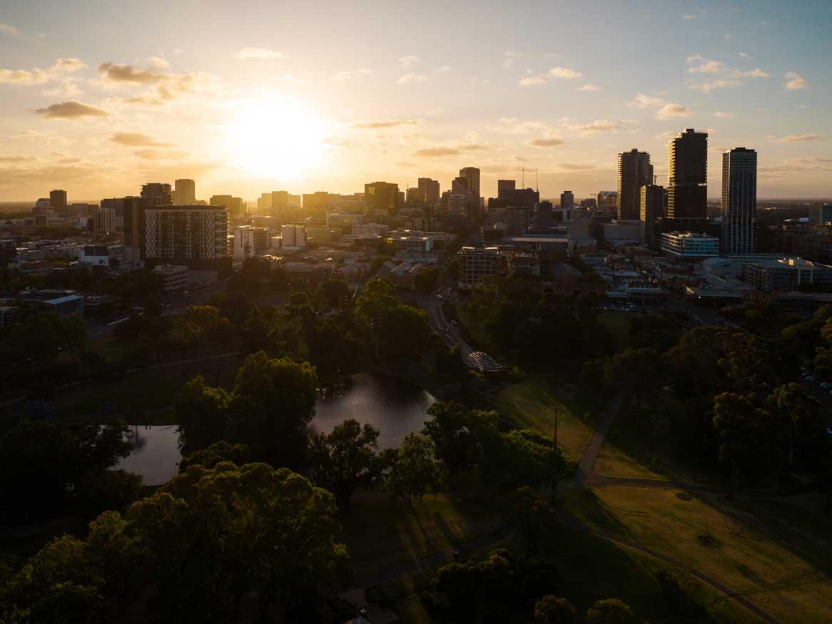 Aerial photo of Adelaide with the sun setting in the background
