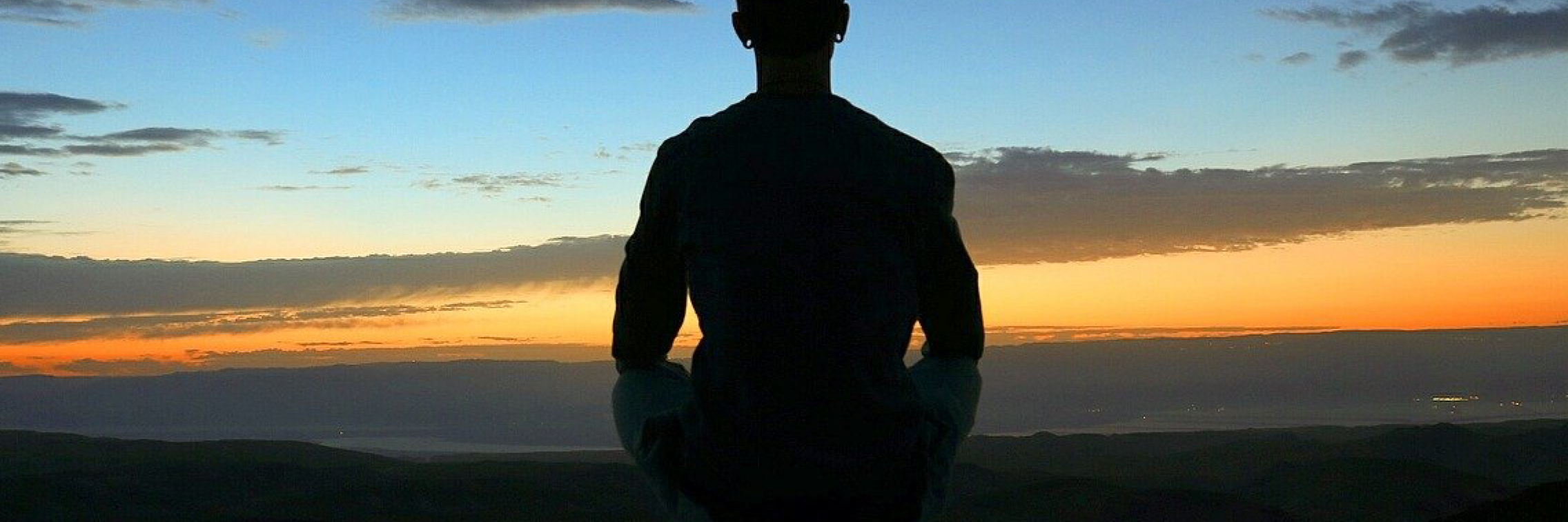 man meditating at dawn - image