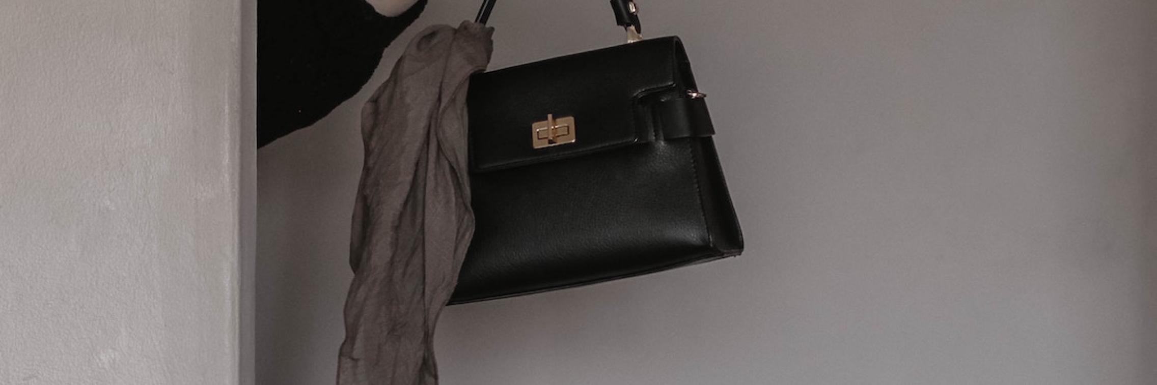 Person holding a handbag.