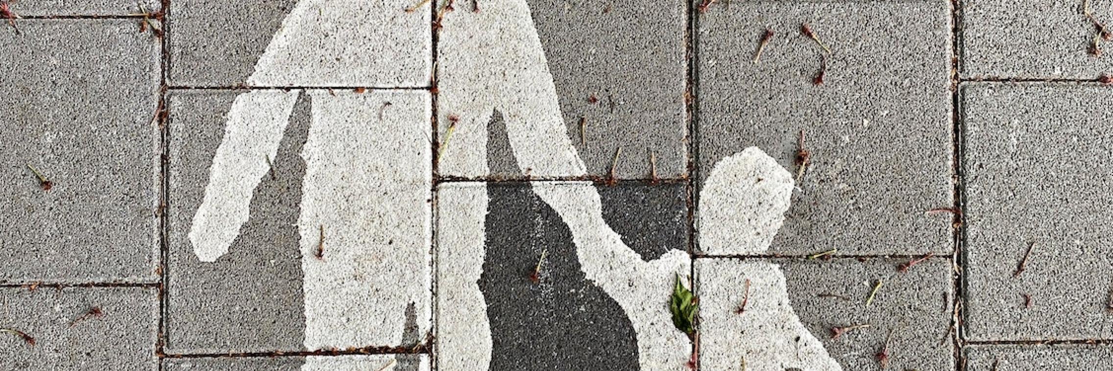 A drawing of a parent and child on the pavement.