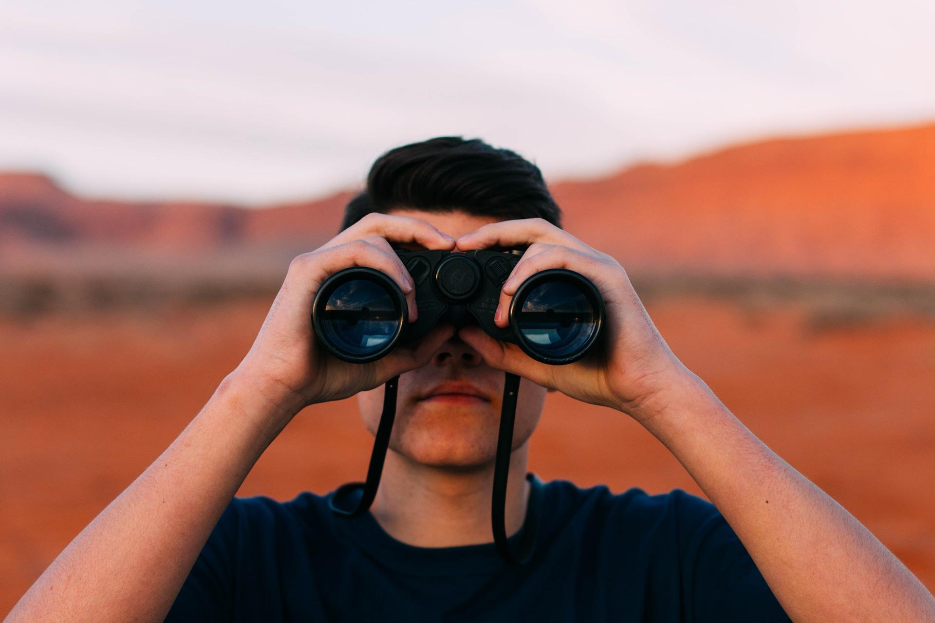 Man looking through binoculars.