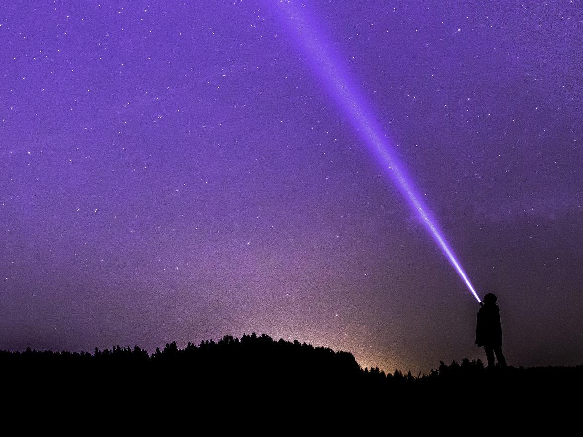 shining a torch into the sky - image