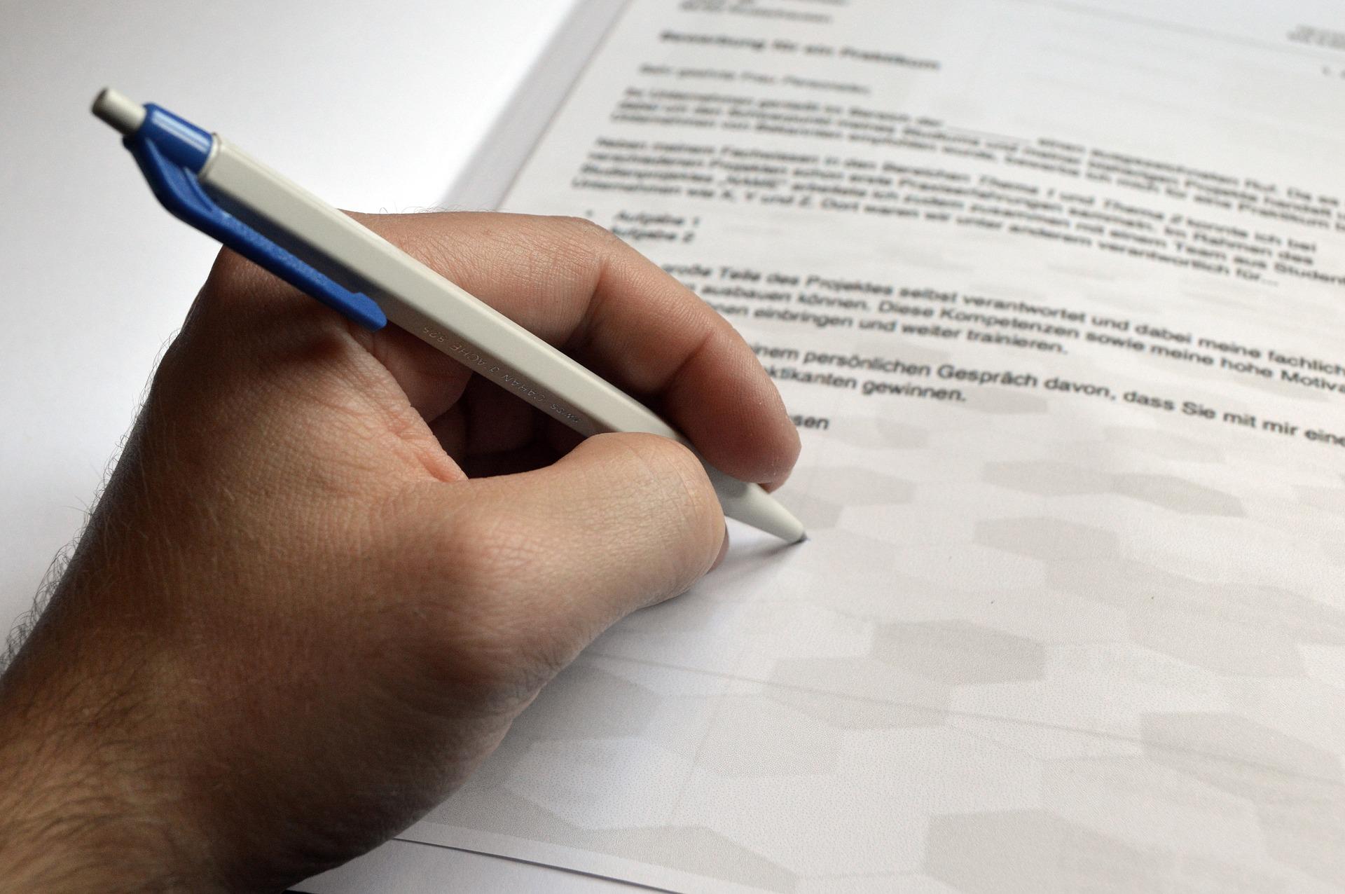 Left hand holding Pen