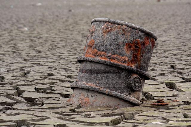 oil barrel buried in desert