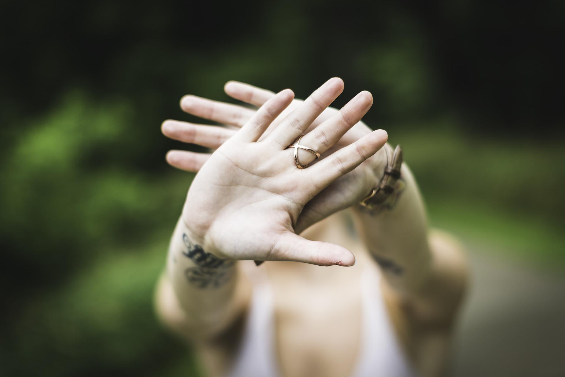 Hands covering face