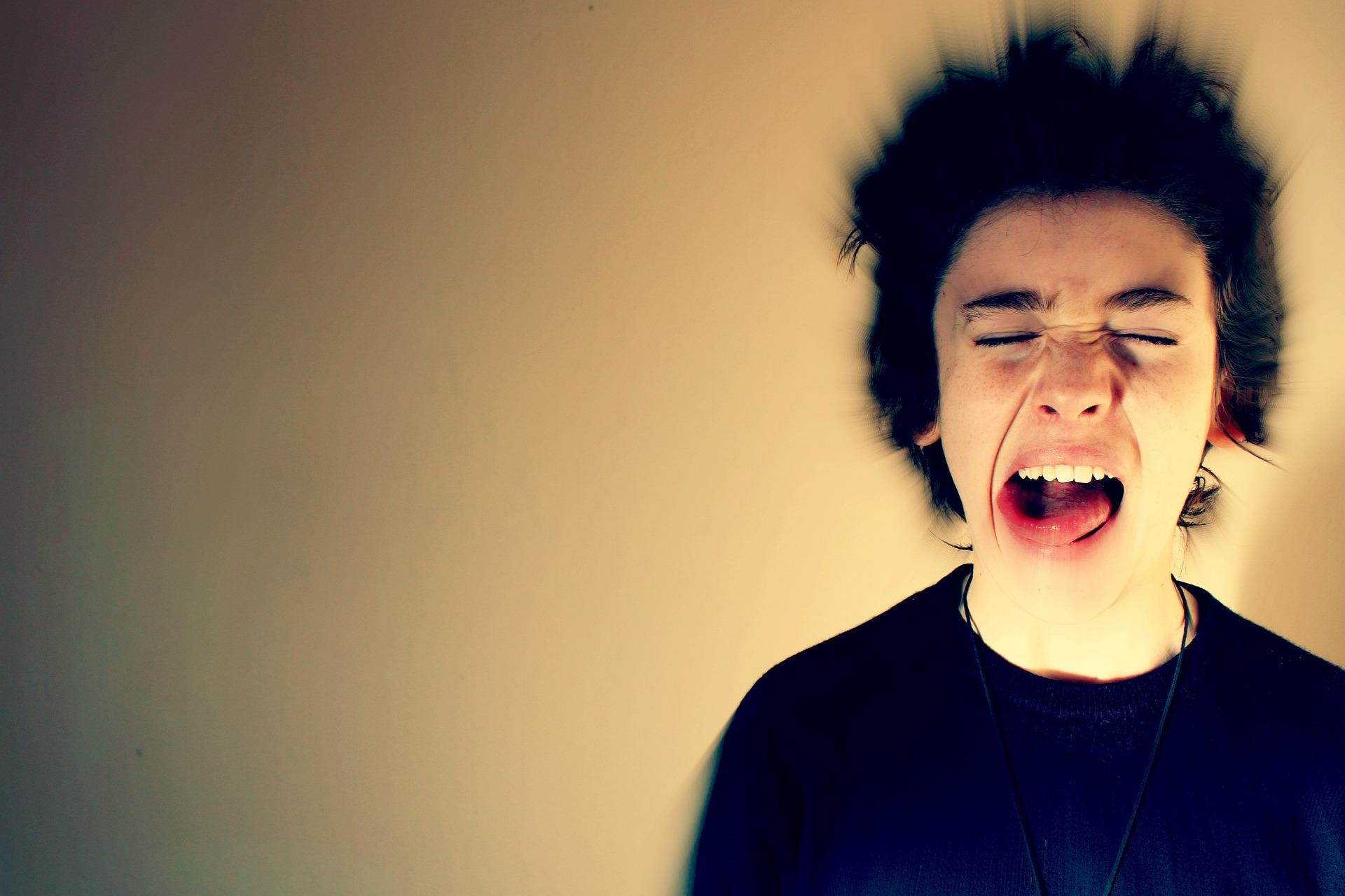 Person screaming with eyes closed