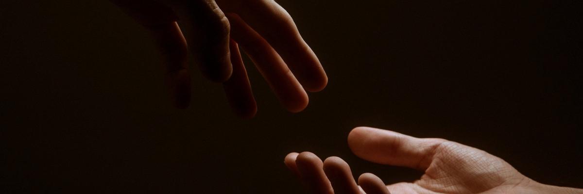 Hands reaching out to each other.