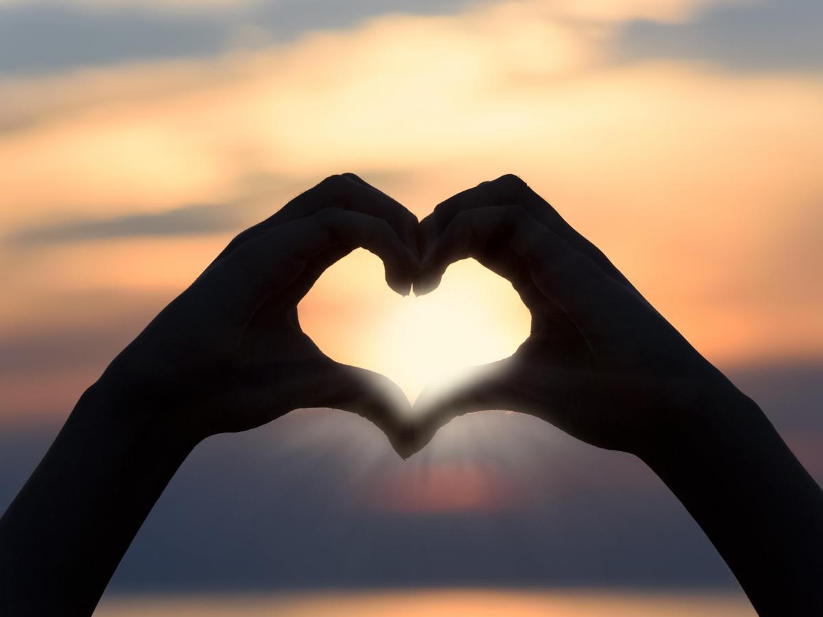 Holding hands up in the shape of a love heart