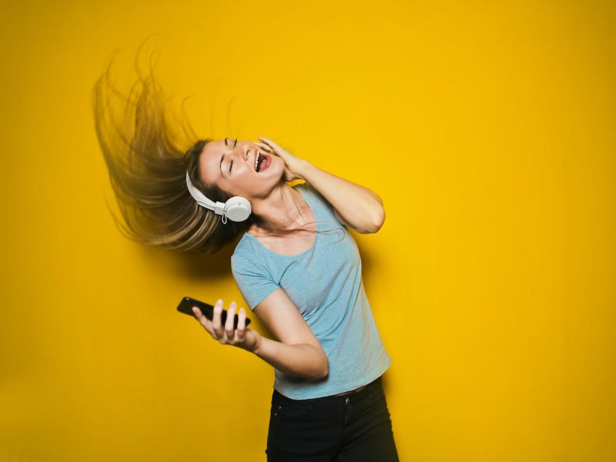 A woman dancing with headphones on.