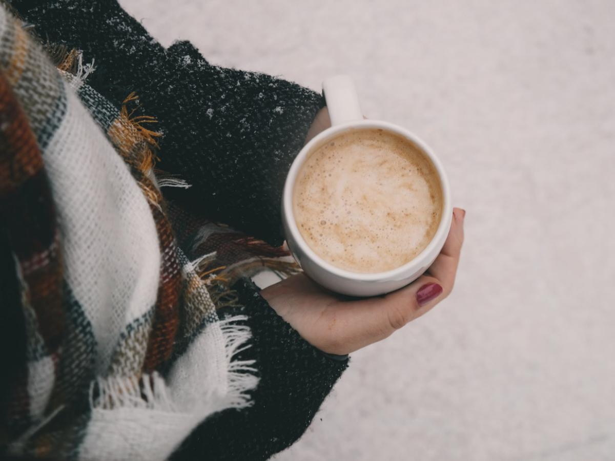 Bird's eye view of coffee in a girl's hands