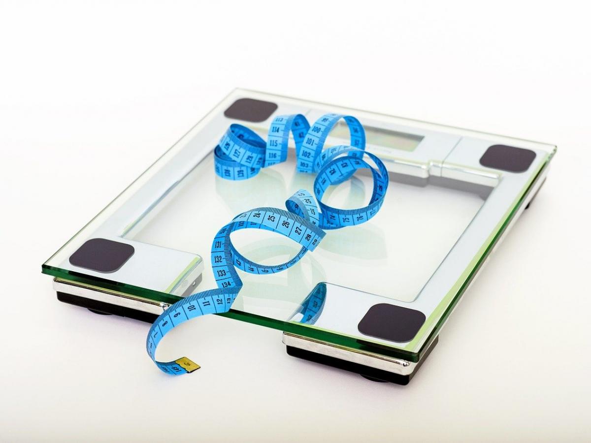 A blue measuring tap on top of glass scales.