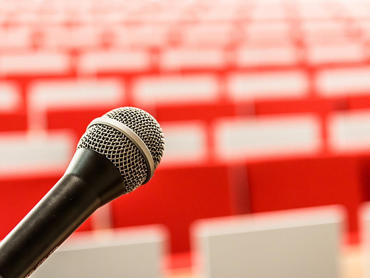 microphone with blurred image of seats in the distance