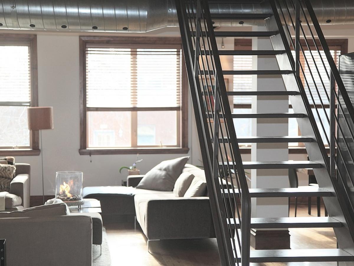 a bright minimally decorated grey-toned apartment with large windows