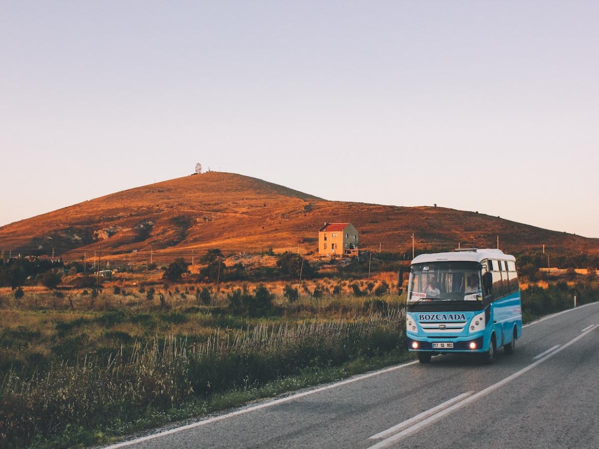 A bus driving in the country side.