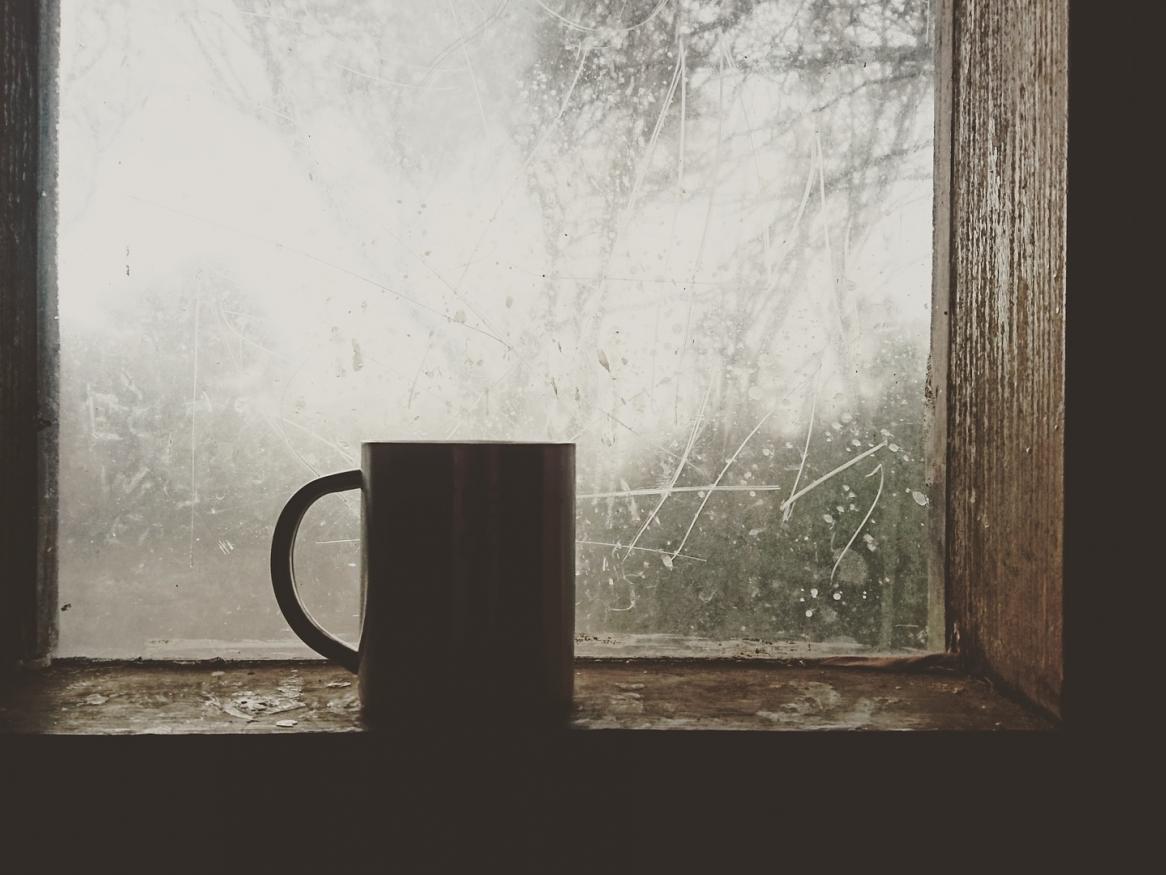Coffee mug and icy window