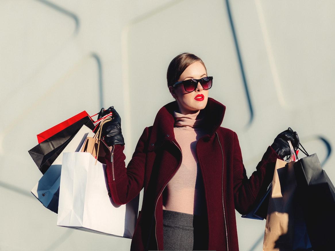 woman holding multiple shopping bags 