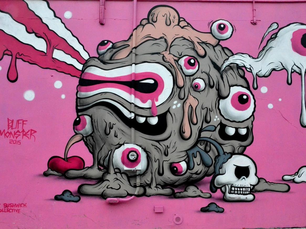 graffiti art of a monster in a pink backdrop