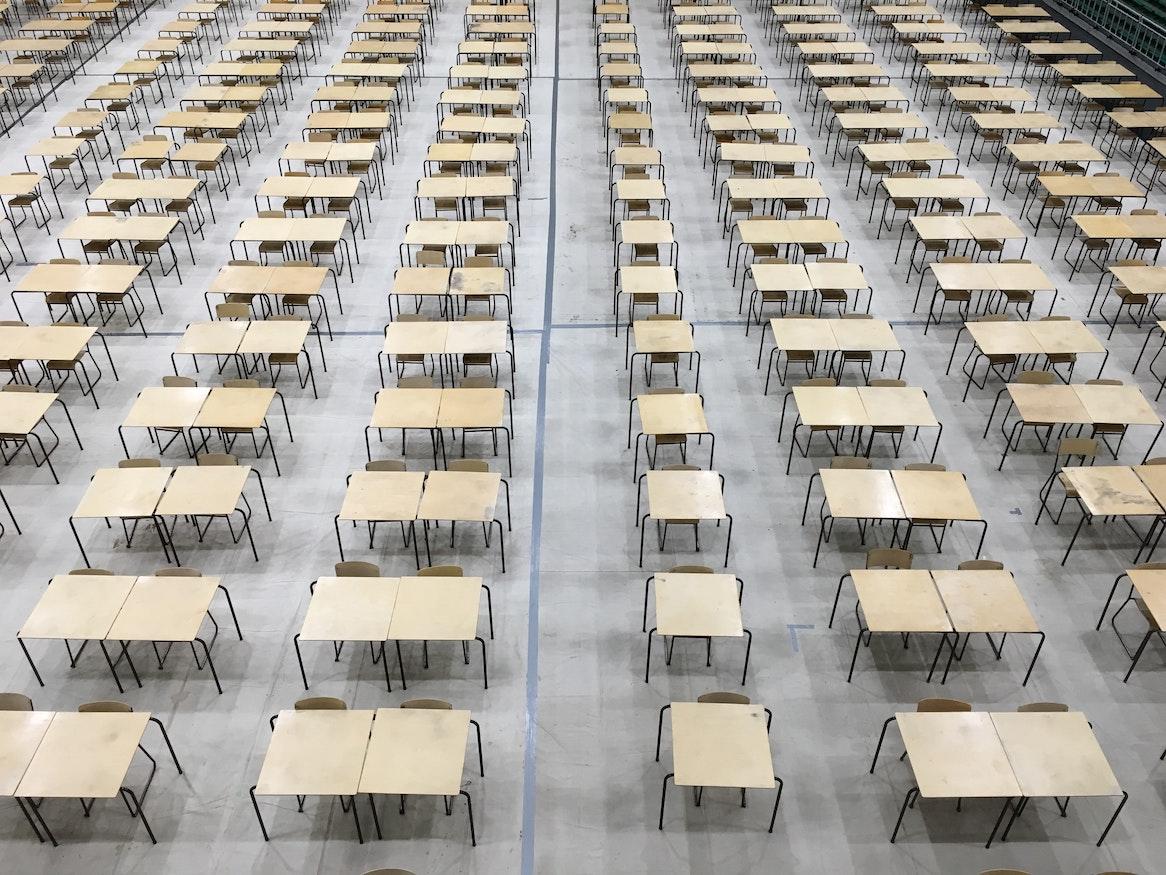 Rows of tables and chairs in exam hall