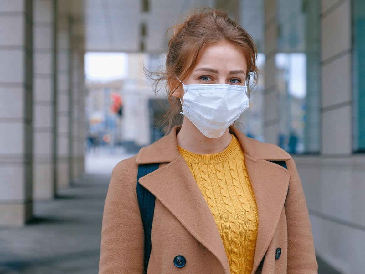 Young woman wearing a white medical mask