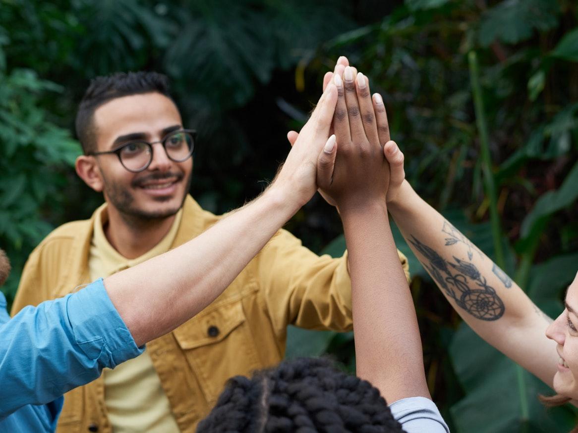 Group of people doing a joined high-five